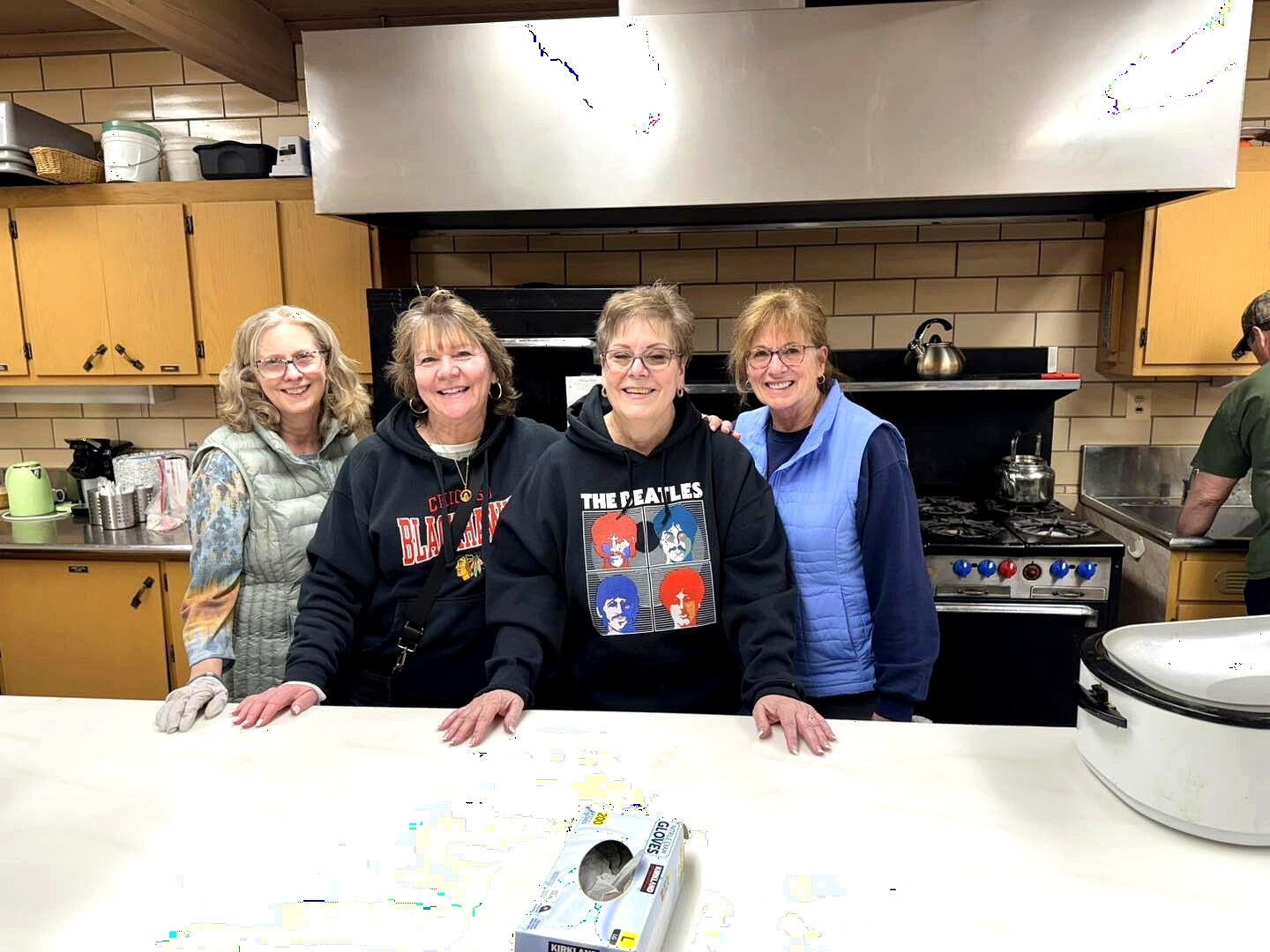 Almost Home Chicago volunteers smiling together in the kitchen